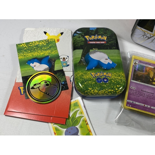 346 - A POKEMON 25TH ANNIVERSARY TIN WITH ASSORTED CARDS, GAME TOKENS ETC