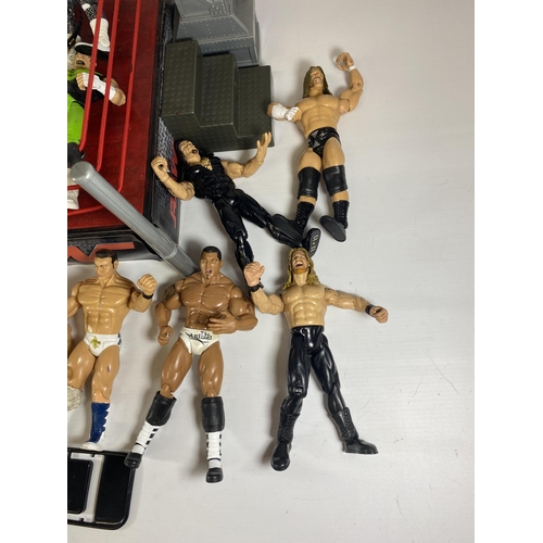 364 - A LARGE COLLECTION OF W.W.E WRESTLING FIGURES IN RING WITH BELTS ETC