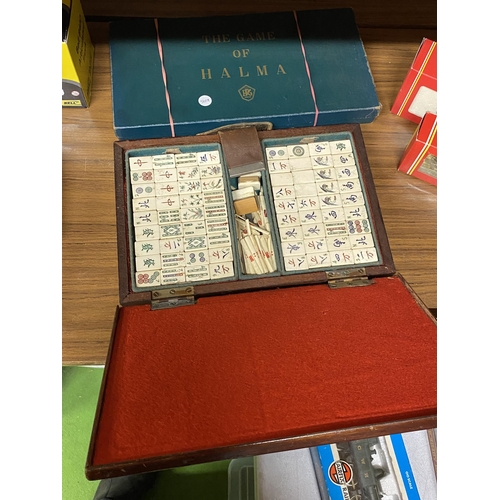 410 - A VINTAGE WOODEN CASED MAHJONG SET AND A BOXED HALMA GAME