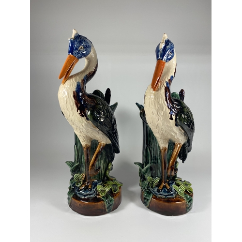 801 - A PAIR OF VICTORIAN MAJOLICA STYLE CONTINENTAL STORK FIGURES HEIGHT 38CM