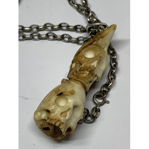 546 - A SILVER NECKLACE WITH A BONE PENDANT