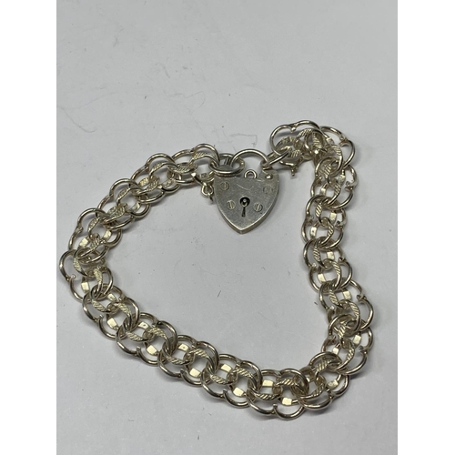 571 - TWO SILVER BRACELETS WITH HEART LOCKS