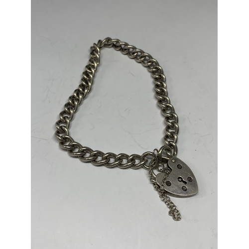 574 - A SILVER BRACELET WITH HEART PADLOCK