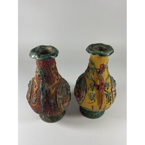 490 - A PAIR OF UNUSUAL CHINESE LACQUERED RELIEF MOULDED DESIGN VASES, HEIGHT 19CM