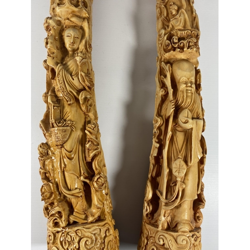 497 - A PAIR OF LARGE RESIN ORIENTAL TUSKS, LENGTH 44CM