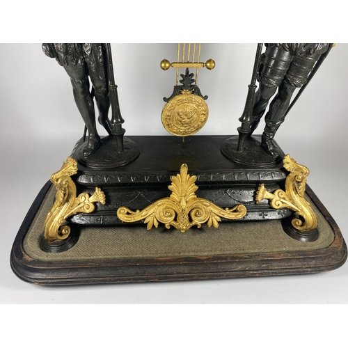 12 - A FRENCH JAPY FERERES SPELTER TWO TRAIN DOMED CLOCK WITH TWIN FIGURAL DESIGN, DOME HEIGHT 64CM, WITH... 