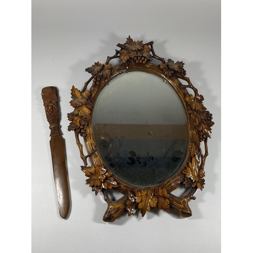 7 - A VINTAGE CARVED WOODEN MIRROR WITH MATCHING LETTER OPENER, MIRROR LENGTH 40CM