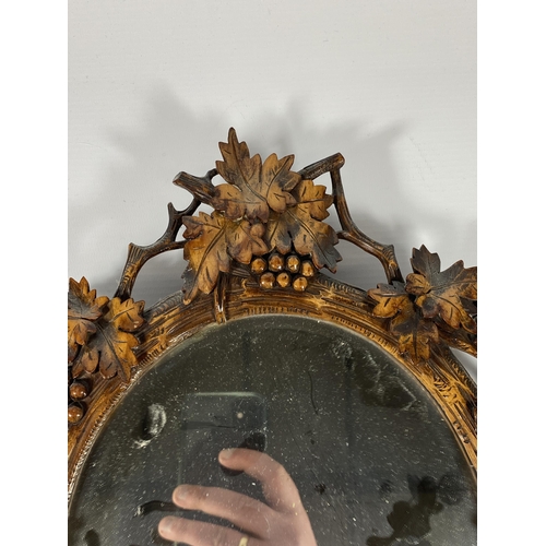 7 - A VINTAGE CARVED WOODEN MIRROR WITH MATCHING LETTER OPENER, MIRROR LENGTH 40CM