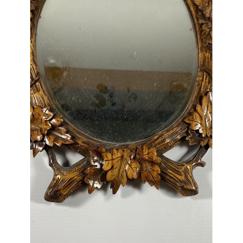 7 - A VINTAGE CARVED WOODEN MIRROR WITH MATCHING LETTER OPENER, MIRROR LENGTH 40CM