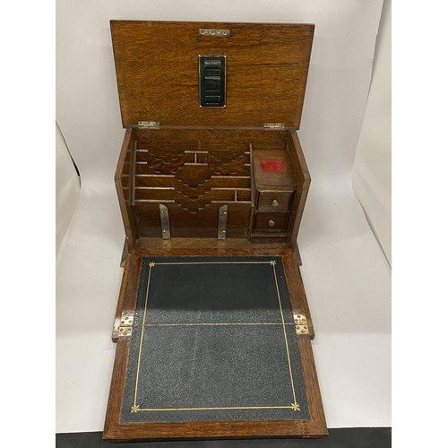 60 - A VINTAGE OAK FOLD OUT WRITING SLOPE BOX WITH BLACK LEATHER INTERIOR, 20 X 33 X 19CM