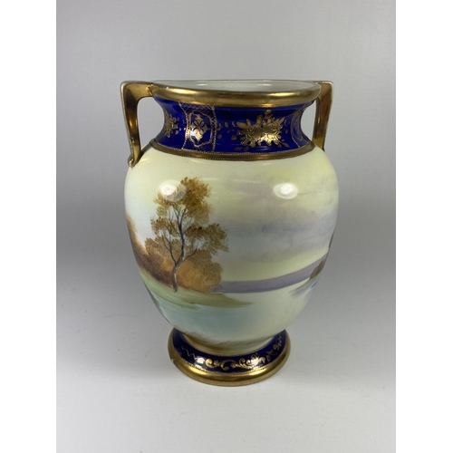 853 - A NORITAKE TWIN HANDLED VASE WITH LAKE SCENE, HEIGHT 22CM, ONE HANDLE A/F