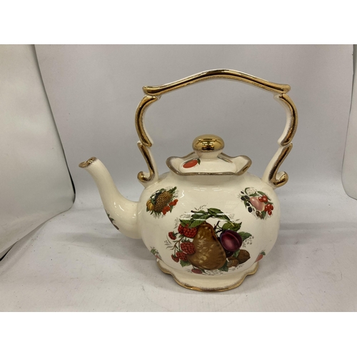 168 - A LARGE CERAMIC KETTLE WITH FRUIT DECORATION