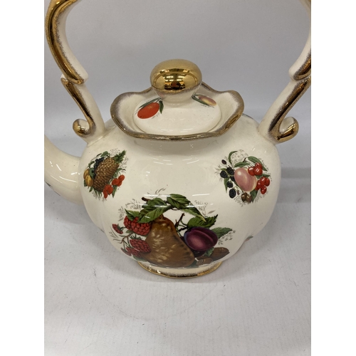 168 - A LARGE CERAMIC KETTLE WITH FRUIT DECORATION