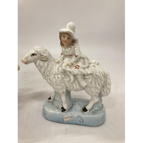 255 - A PAIR OF STAFFORDSHIRE FIGURES OF A BOY AND GIRL SAT ON SHEEP