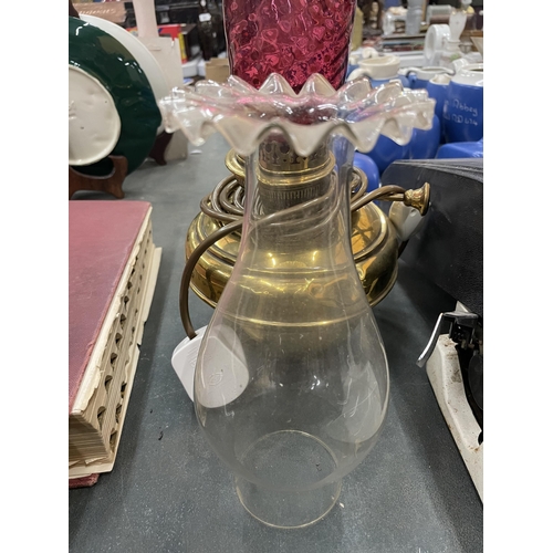 278 - A BRASS OIL LAMP COVERTED TO ELECTRIC WITH TWO FUNNELS ONE CRANBERRY GLASS AND THE OTHER  CLEAR GLAS... 