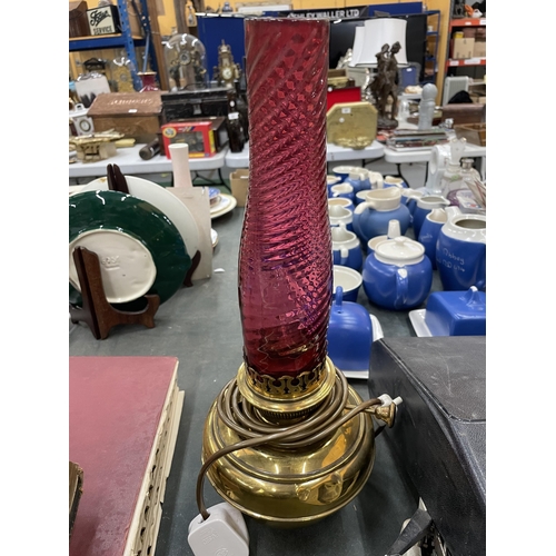 278 - A BRASS OIL LAMP COVERTED TO ELECTRIC WITH TWO FUNNELS ONE CRANBERRY GLASS AND THE OTHER  CLEAR GLAS... 