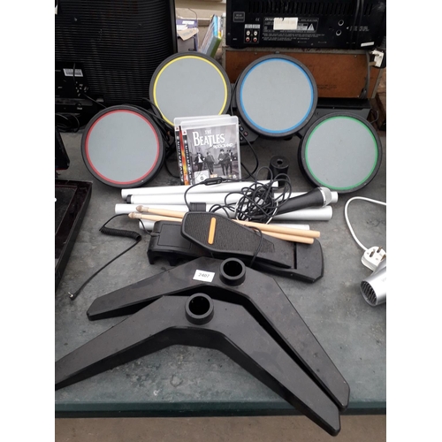 2407 - A PLAYSTATION DRUM KIT AND TWO GAMES TO INCLUDE GUITAR HERO WORLD TOUR