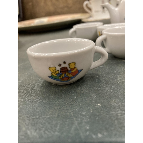150 - A MINIATURE CHILD'S POTTERY TEASET TO INCLUDE TEAPOT, JUGS, CUPS, ETC WITH A TEDDY BEARS PICNIC DESI... 