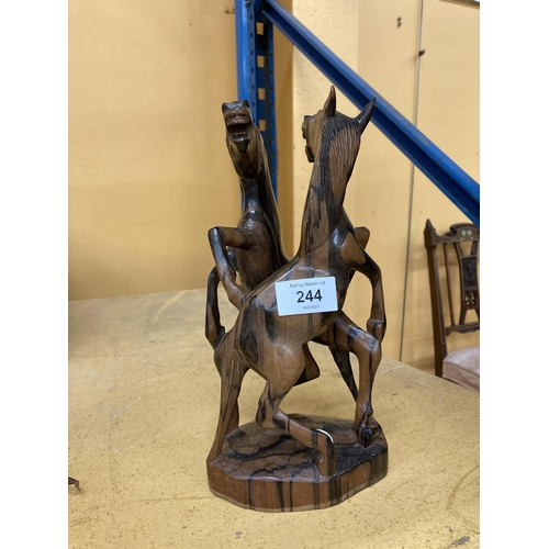 244 - A HARDWOOD SCULPTURE OF FIGHTING HORSES