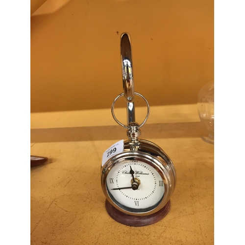 299 - A CHROME POCKET WATCH STYLE CLOCK ON A CHROME STAND WITH WOODEN BASE