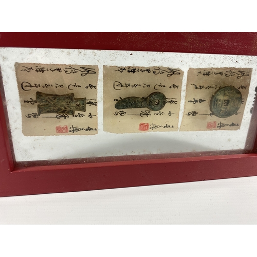 430A - AN ORIENTAL FRAMED ARTIFACT DISPLAY