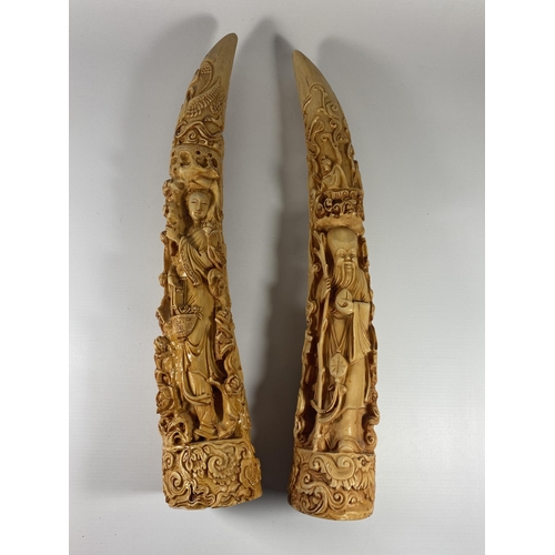 497 - A PAIR OF LARGE RESIN ORIENTAL TUSKS, LENGTH 44CM