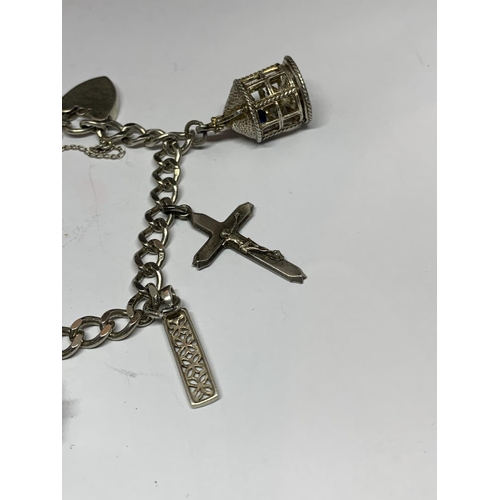 545 - A SILVER BRACELET WITH SEVEN VARIOUS CHARMS