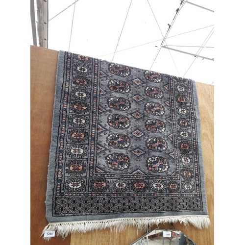 2498 - A BLACK PATTERNED FRINGED RUG