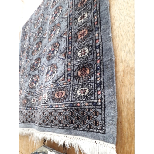 2498 - A BLACK PATTERNED FRINGED RUG