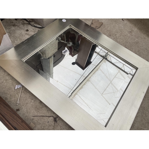 2853 - AN OAK FRAMED WALL MIRROR AND SILVER COLOURED MIRROR