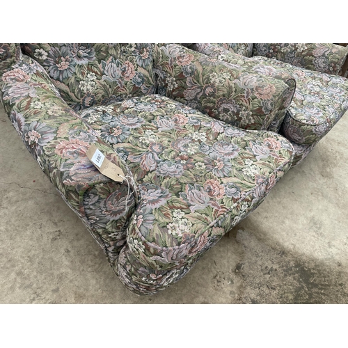 2881 - A PAIR OF FLORAL UPHOLSTERED WINGED EASY CHAIRS