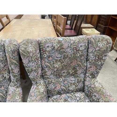 2881 - A PAIR OF FLORAL UPHOLSTERED WINGED EASY CHAIRS