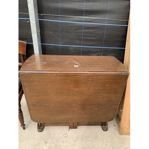 2920 - A MID 20TH CENTURY OAK DROP LEAF DINING TABLE WITH TWO END CUPBOARDS AND ONE DRAWER