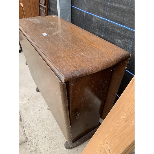 2920 - A MID 20TH CENTURY OAK DROP LEAF DINING TABLE WITH TWO END CUPBOARDS AND ONE DRAWER