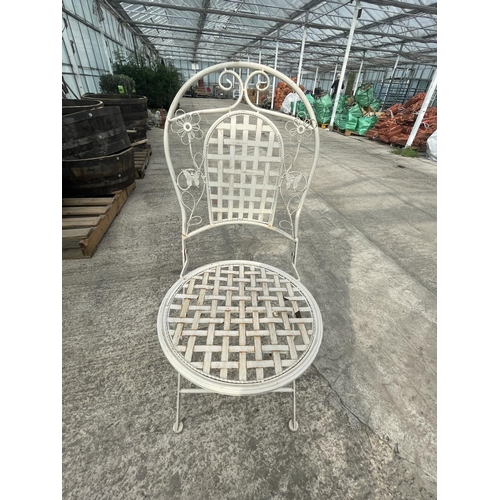 87 - A DECORATIVE METAL BISTRO TABLE COMPRISING OF A ROUND TABLE AND TWO CHAIRS NO VAT