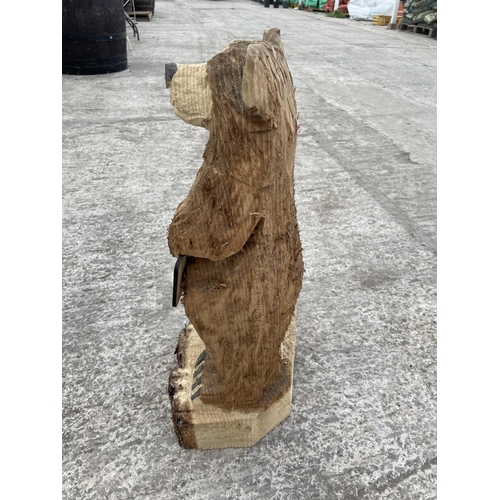 99 - A CARVED WOODEN ORNAMENT OF A WELCOME BEAR NO VAT