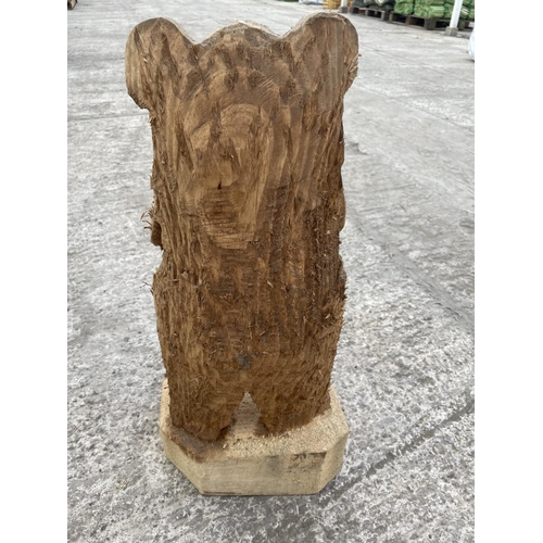 99 - A CARVED WOODEN ORNAMENT OF A WELCOME BEAR NO VAT