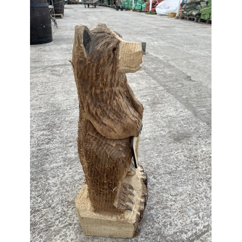 99 - A CARVED WOODEN ORNAMENT OF A WELCOME BEAR NO VAT