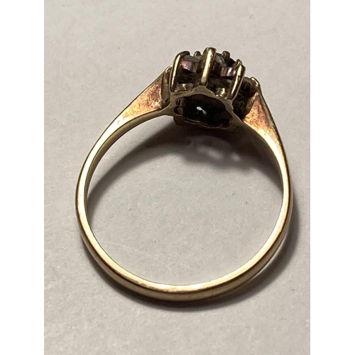 532 - A 9 CARAT YELLOW GOLD RING WITH CENTRE GARNET AND FIVE SURROUNDING (TWO MISSING SHOULD HAVE SEVEN) C... 