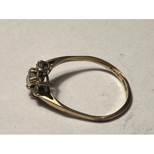 537 - A 9 CARAT GOLD RING WITH CLEAR STONES IN A FLOWER DESIGN SIZE M/N GROSS WEIGHT 1.24 GRAMS