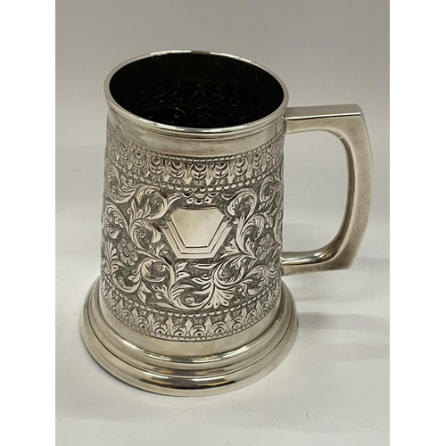 1 - A STERLING SILVER TANKARD WITH FOLIATE CHASED AND ENGRAVED DESIGN WITH VACANT CARTOUCHE, STAMPED TO ... 