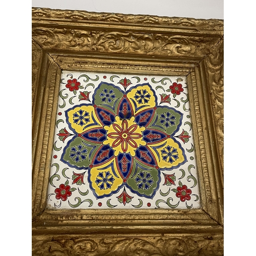 15 - A DECORATIVE GILT FRAMED POSSIBLY LONGWY FRENCH POTTERY TILED PLAQUE