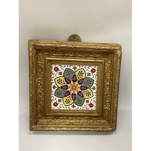 15 - A DECORATIVE GILT FRAMED POSSIBLY LONGWY FRENCH POTTERY TILED PLAQUE