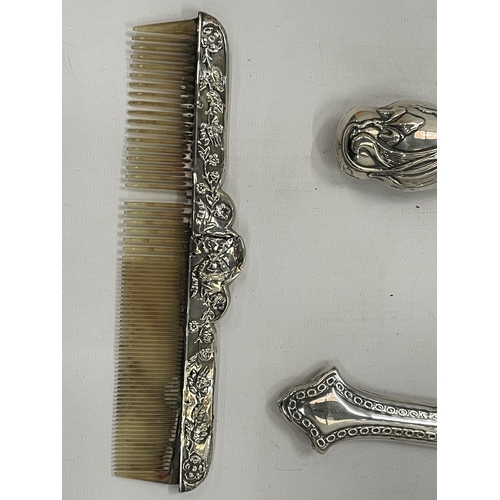 33 - A GEORGE V SILVER BACKED THREE PIECE DRESSING SET COMPRISING HAND MIRROR, BRUSH AND COMB