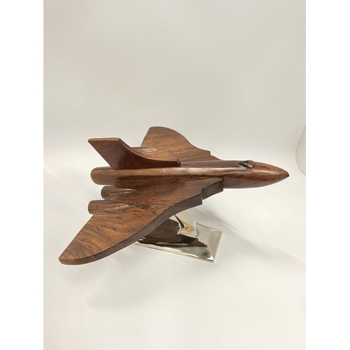 57 - A WOODEN MODEL OF A VULCAN BOMBER ON A CHROME BASE