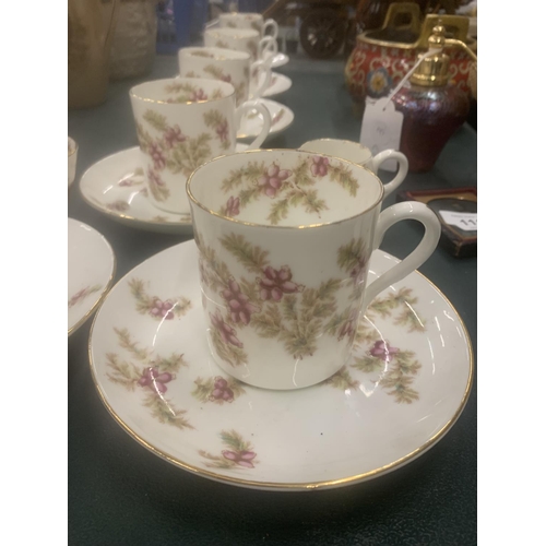 115 - A VINTAGE CHINA PART TEASET WITH PINK FLORAL PATTERN TO INCLUDE CUPS, SAUCERS, CREAM JUG AND A SUGAR... 