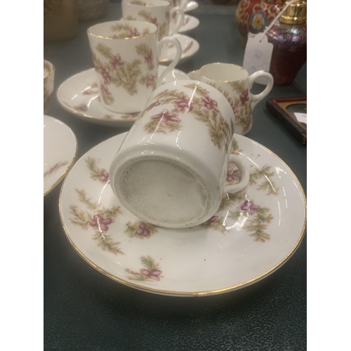 115 - A VINTAGE CHINA PART TEASET WITH PINK FLORAL PATTERN TO INCLUDE CUPS, SAUCERS, CREAM JUG AND A SUGAR... 