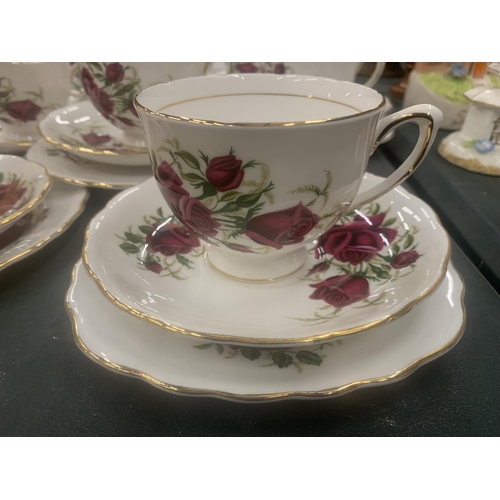 117 - A COLCLOUGH TEASET WITH ROSE PATTERN TO INCLUDE CUPS, SAUCERS, SIDE PLATES, A CAKE PLATE, CREAM JUG ... 