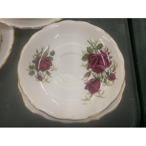 117 - A COLCLOUGH TEASET WITH ROSE PATTERN TO INCLUDE CUPS, SAUCERS, SIDE PLATES, A CAKE PLATE, CREAM JUG ... 