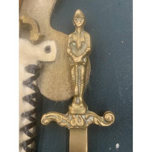 119 - AN ORNATE KNIFE IN AN ANIMAL SKIN SHEATH AND A BRASS LETTER OPENER